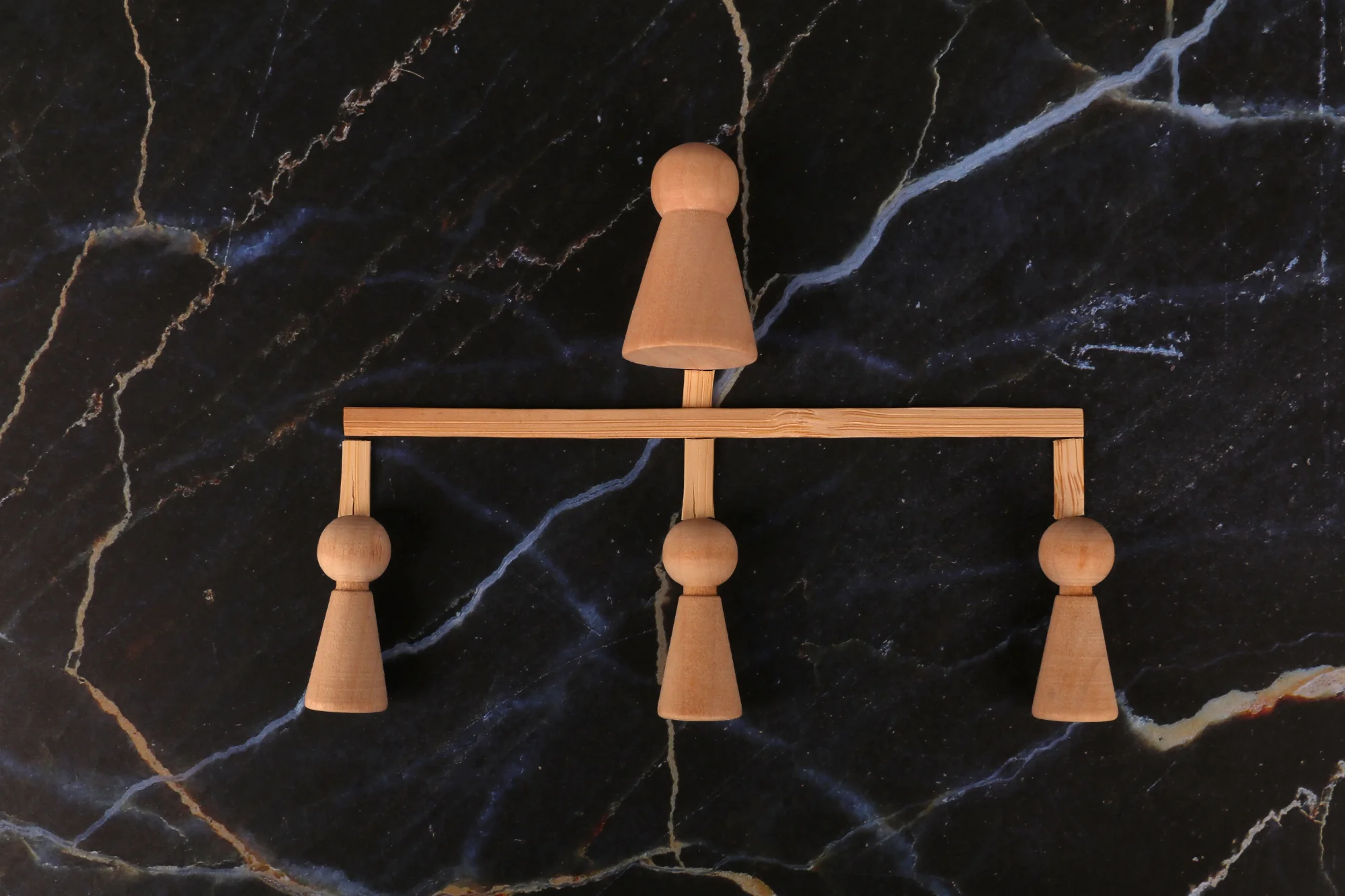 Wooden figures illustrating a phased AI operating model with gradual growth.