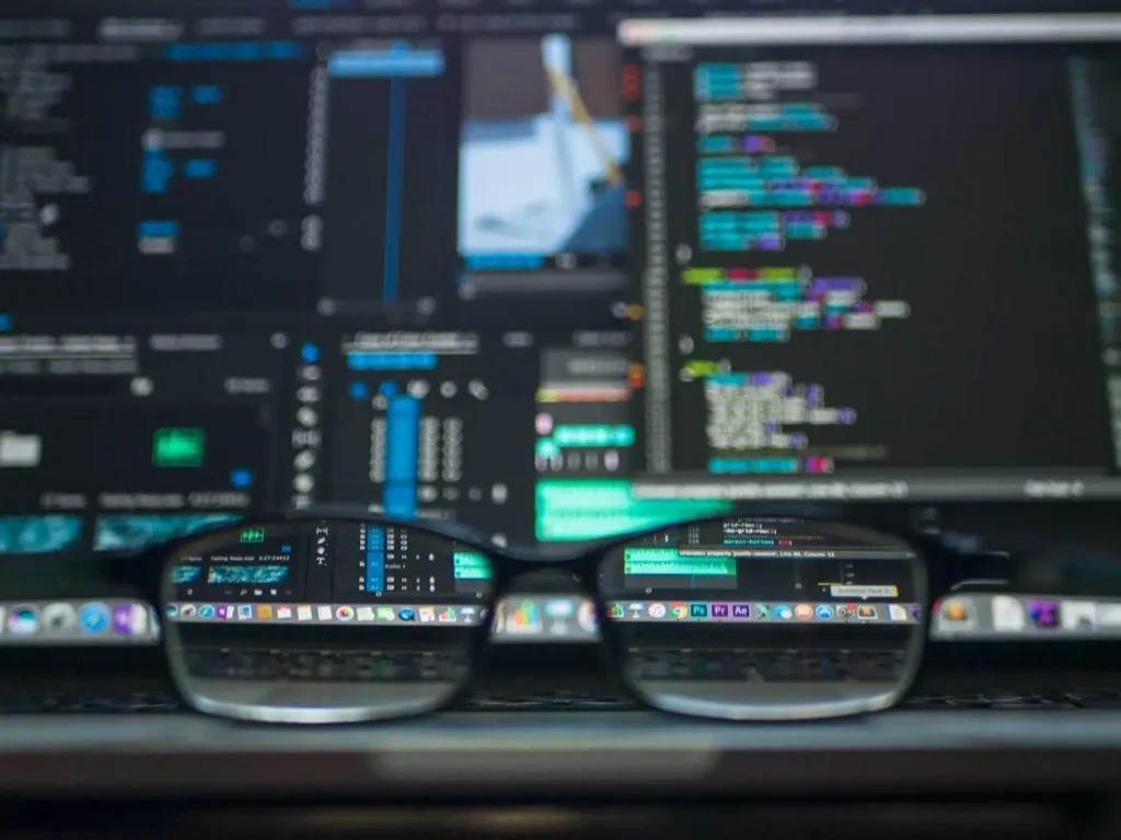 AI code and analytics dashboards on a laptop screen
